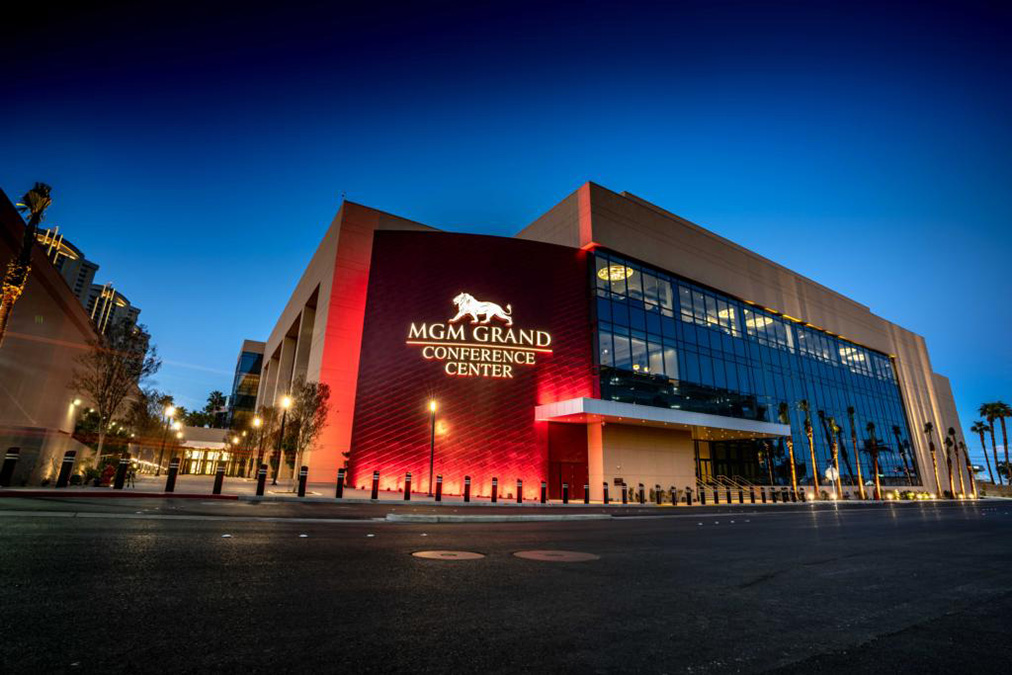 The MGM Grand Conference Center glows red in the dusk.