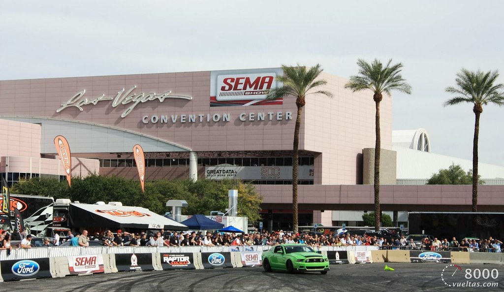 A green car races outside the 2012 SEMA show at the Las Vegas Convention Center.