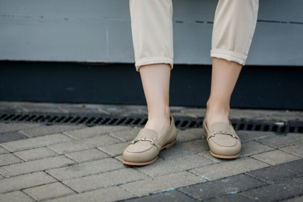 A woman wearing tan loafers. Your trade show attire ideas should take both comfort and professionalism into account. Shoes like these help avoid sore feet.
