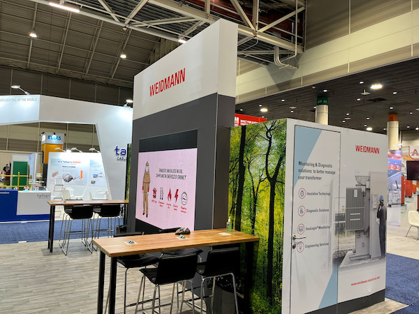 Another angle of the video wall trade show booth that Cardinal created for Weidmann, fitting seamlessly with the booth's tables and chairs for conversations with prospective clients.