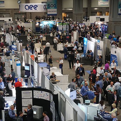 Attendees at the 2022 Experience Power conference mingle among exhibition booths.
