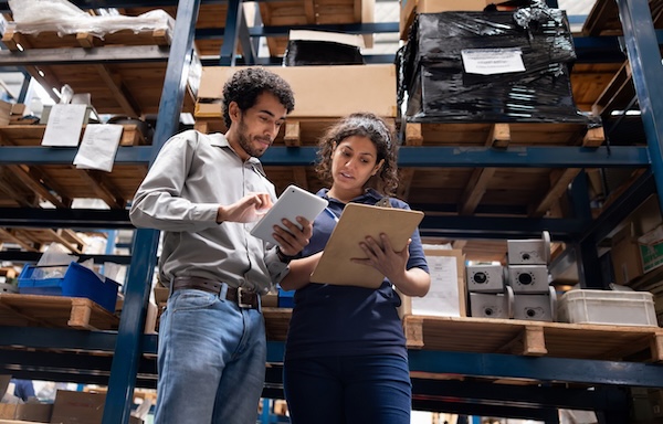 Foreperson discussing shipping of trade show materials in a warehouse