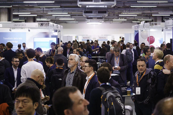 Attendees at the 2022 Experience Power conference mingle among exhibition booths.