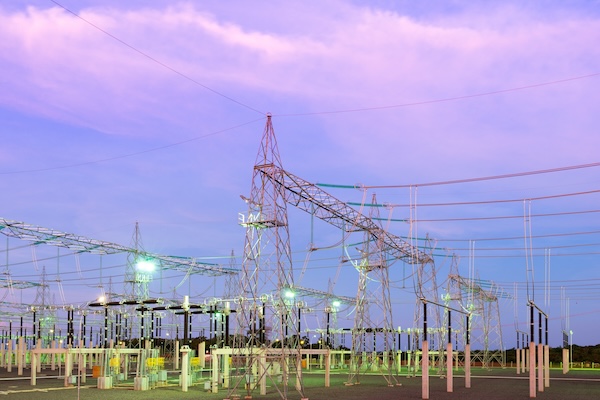 A power plant at night representing some of the tech discussed at DISTRIBUTECH International