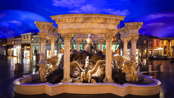 The MGM Grand Conference Center glows red in the dusk.