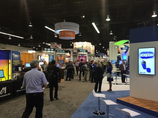 Pharmacy Futures Attendees at the 2022 Experience Power conference mingle among exhibition booths.