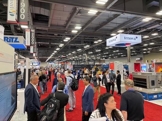 Attendees at the 2022 Experience Power conference mingle among exhibition booths.