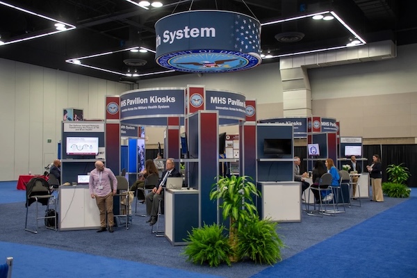 Attendees at the 2022 Experience Power conference mingle among exhibition booths.