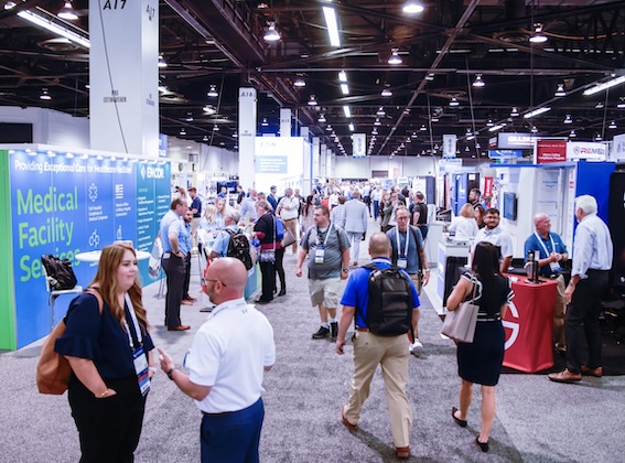 Health Care Facilities Innovation Conference Attendees at the 2022 Experience Power conference mingle among exhibition booths.
