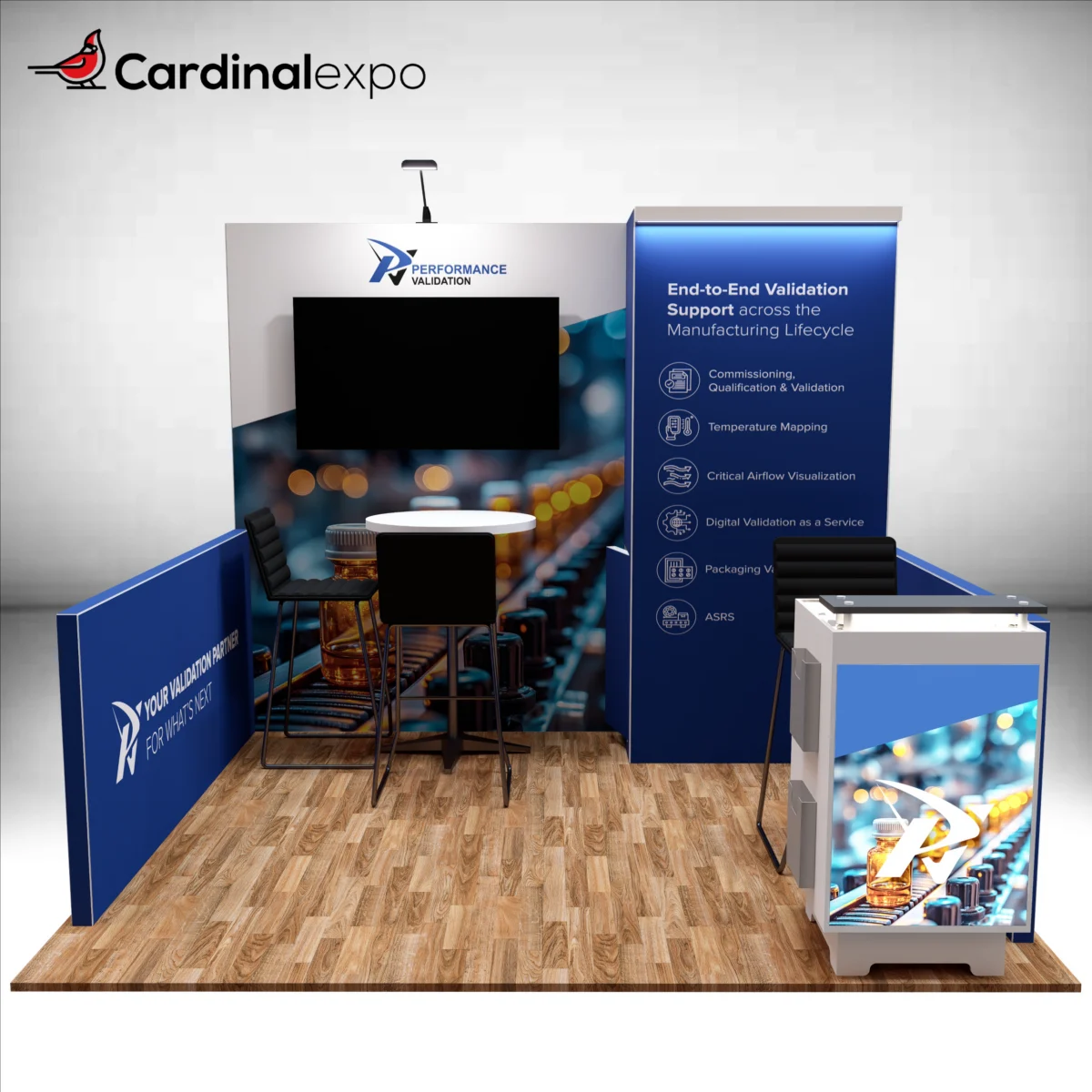 Front perspective of an exhibition booth structure with a backlit reception counter, TV monitor, side wall, and bistro table.