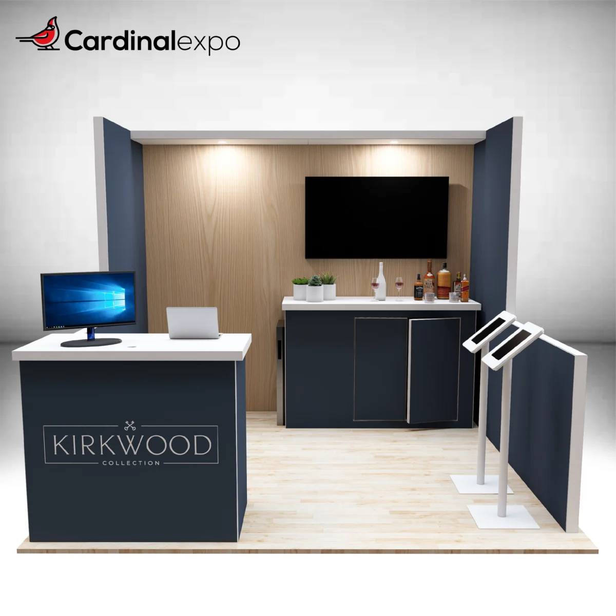 Frontal view of a 10x10 booth containing a greeting desk, wood-accented back wall, TV, storage, and tablet kiosks.