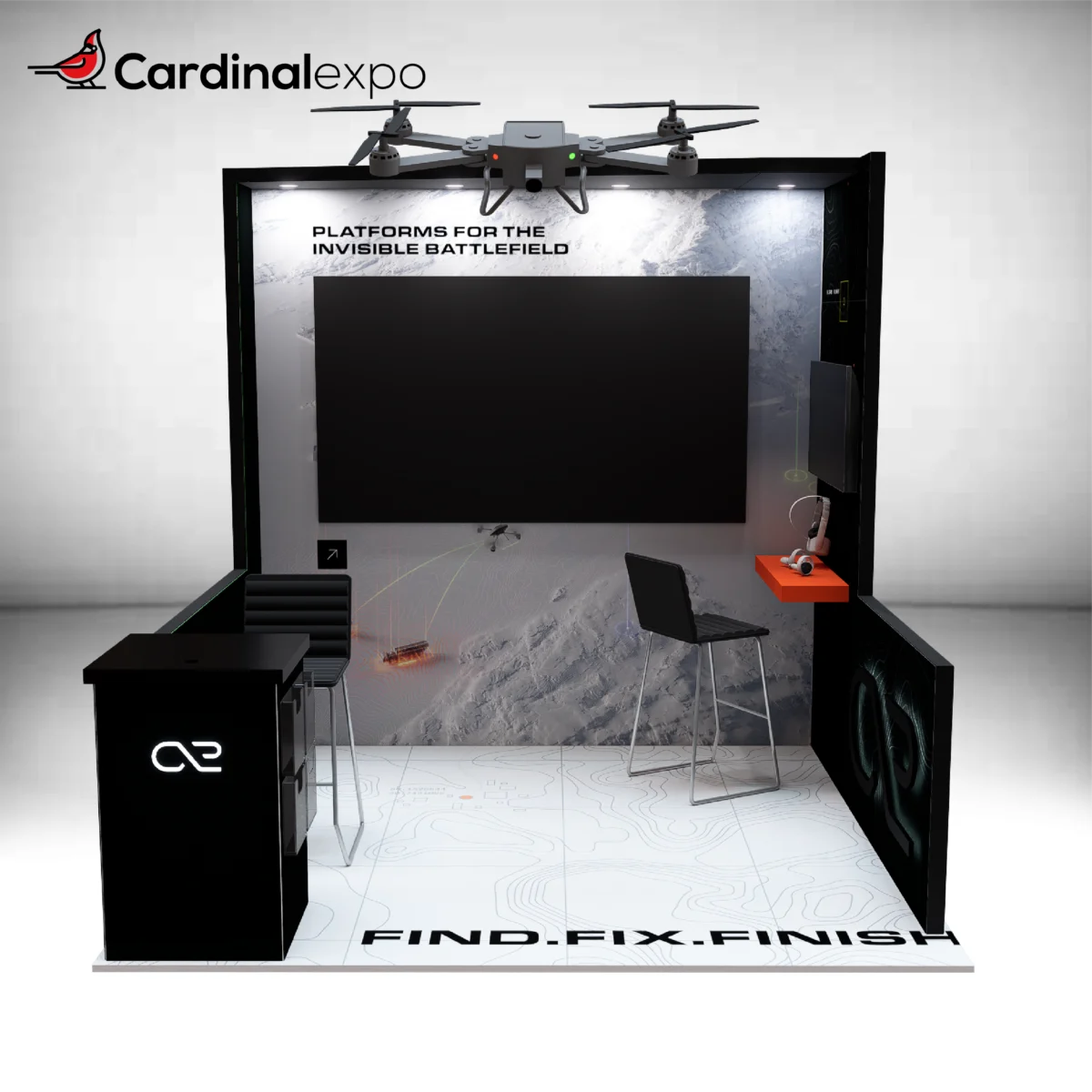 Straight-on view of a 10x10 display showcasing a large TV, hanging drone prop, reception desk, and workstation.
