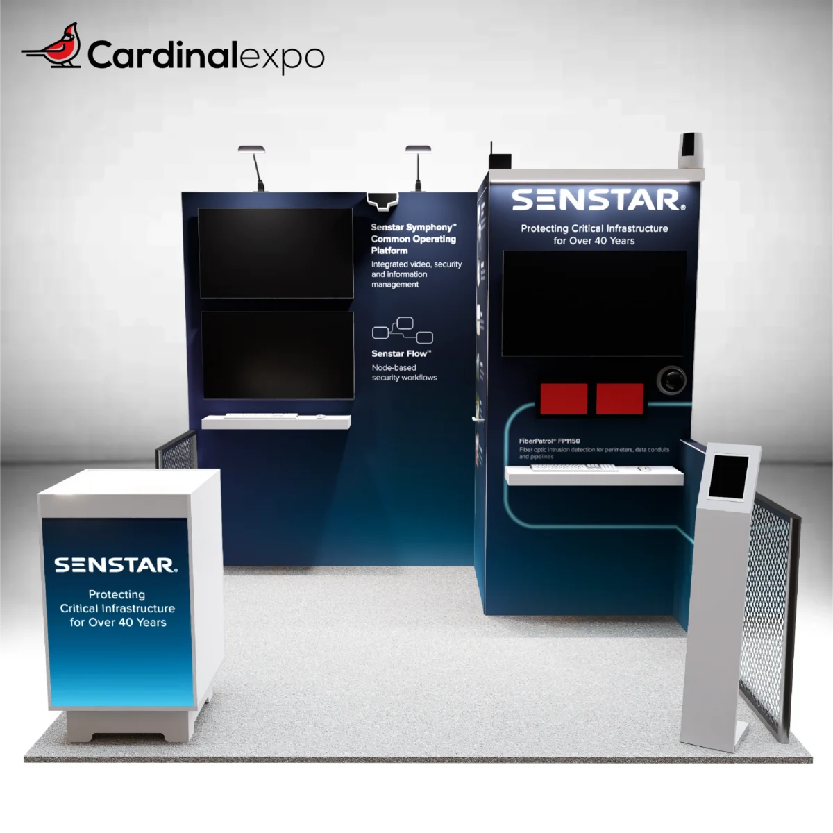 Frontal perspective of a 10x10 exhibit featuring an L-shaped backwall with monitors, chainlink fences, kiosk, and podium.