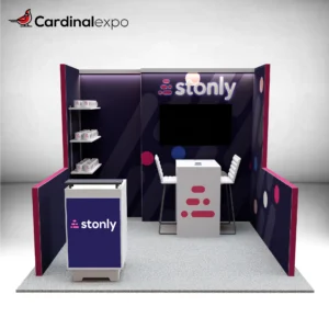 Front perspective of a 10x10 booth featuring a 3D halo-lit sign, backwall TV, meeting table, shelves, and reception podium.