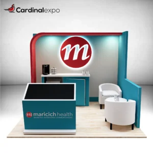 Frontal perspective of a 10x10 exhibit featuring a touch kiosk, canopy backwall with 3D halo-lit sign, and lounge chairs.