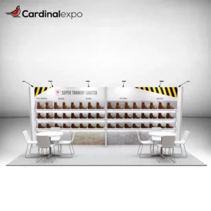 Front view of a 10x20 trade show display featuring extensive backwall shelving, overhead arm lights, and two table sets.