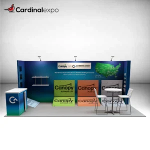 Front view of a 10x20 trade show booth featuring branded product display ramps along the backwall, wall-mounted shelving, a bistro table set, and a front reception counter.