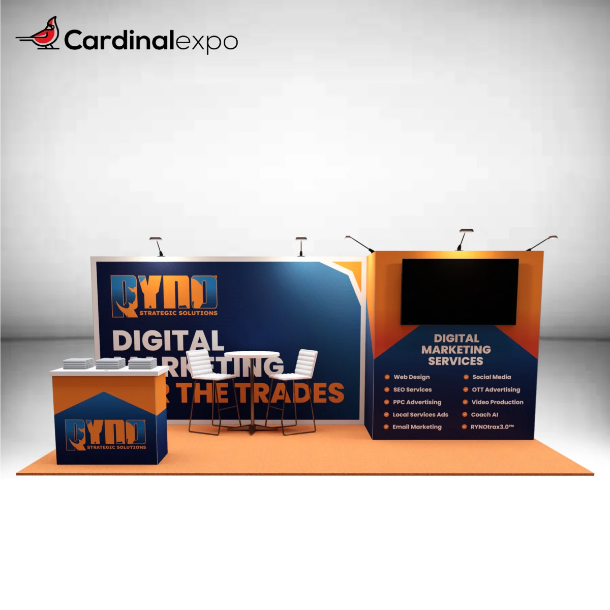 Front view of a 10x20 trade show booth featuring orange and blue branded graphics, a front reception desk, central meeting table set, and a media wall tower with a large TV monitor.