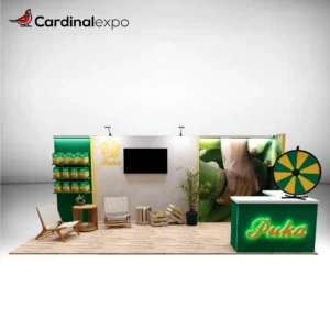 Front view of a 10x20 trade show booth rental featuring a green reception counter with a 3D backlit logo sign, tabletop prize wheel, TV screen, 3D backwall logo sign, and product display shelves.