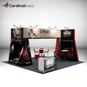Front-left angle of a 20x20 booth structure highlighting an overhead graphic beam, backlit reception desk, and high-top seating.