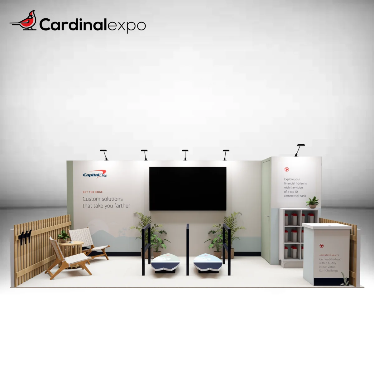 Front view of a 10x20 trade show booth rental featuring dual surf simulator platforms, a wall-mounted TV display, lounge chairs, storage room, and reception desk.