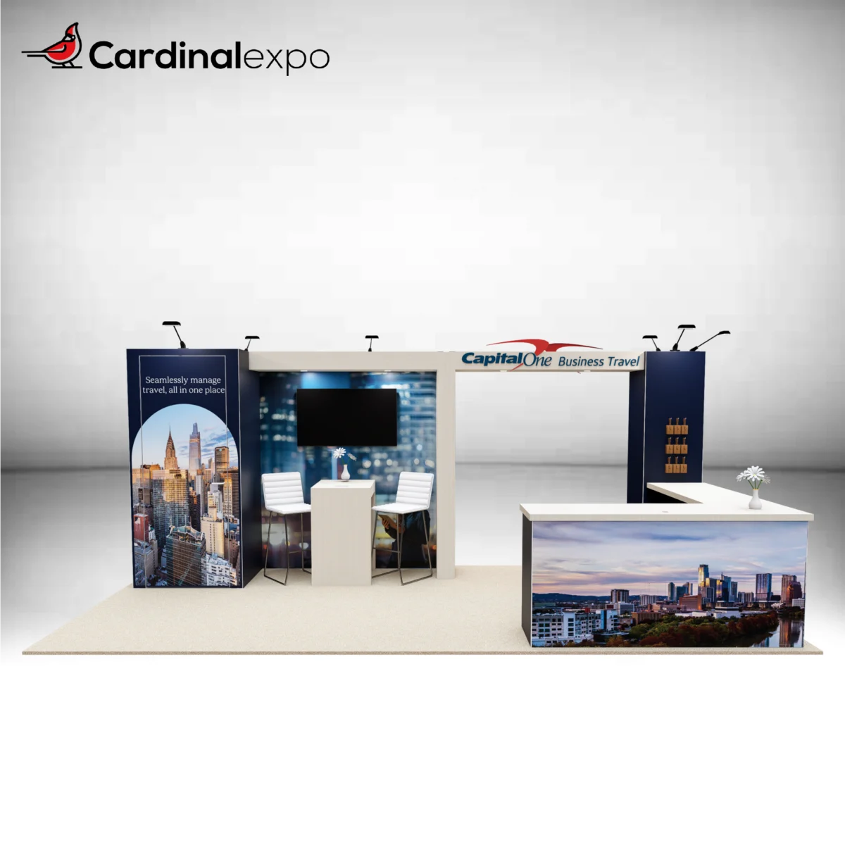 Front view of a 10x20 island trade show booth rental featuring an overhead header with a 3D backlit logo sign, city graphic panels, TV monitor, and L-shaped reception desk.