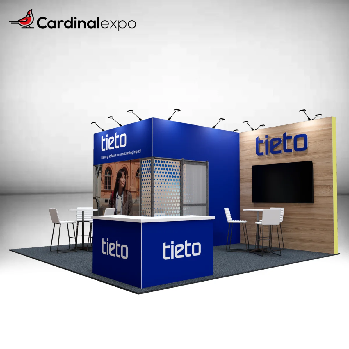 Front-right view of a 20x20 trade show booth rental showcasing a wood-grain accent backwall with a 3D backlit logo sign, TV screen, blue reception desk, and semi-private conference room.